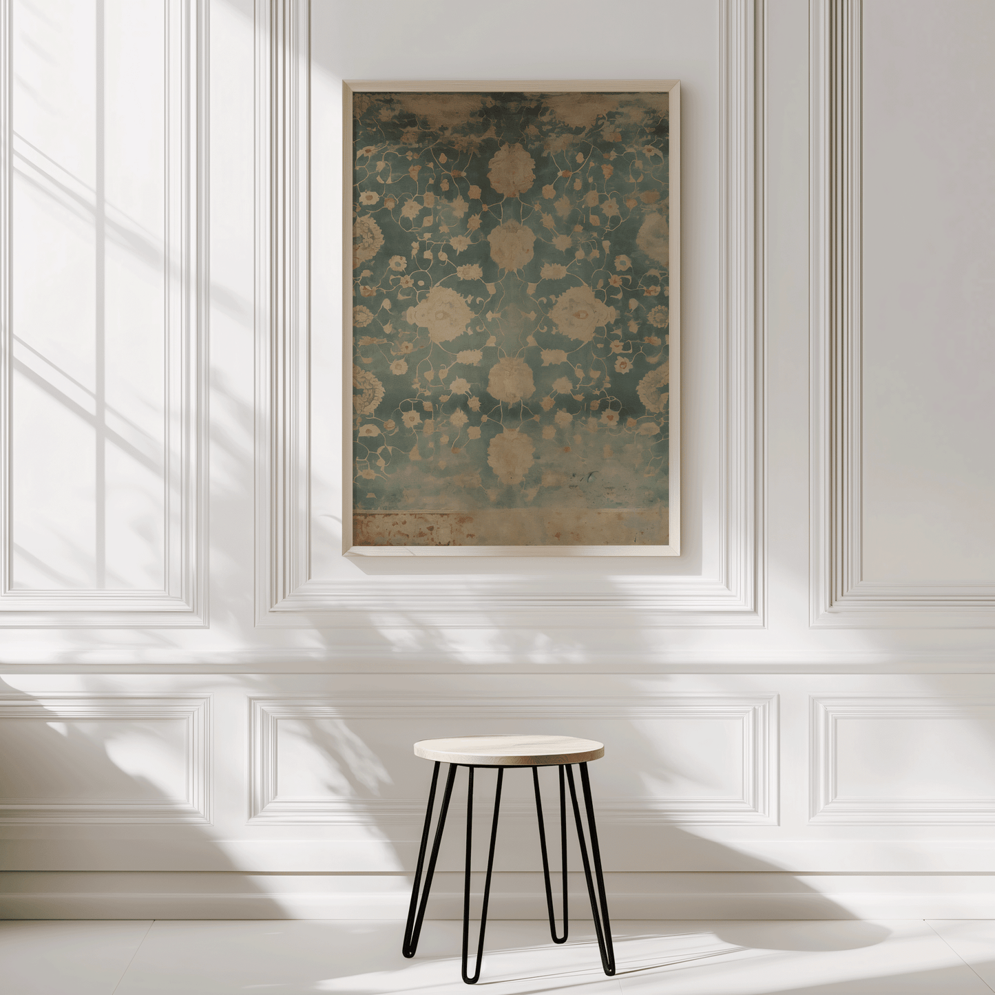 Framed abstract tapestry-inspired floral wall art on a wall with a small stool in front