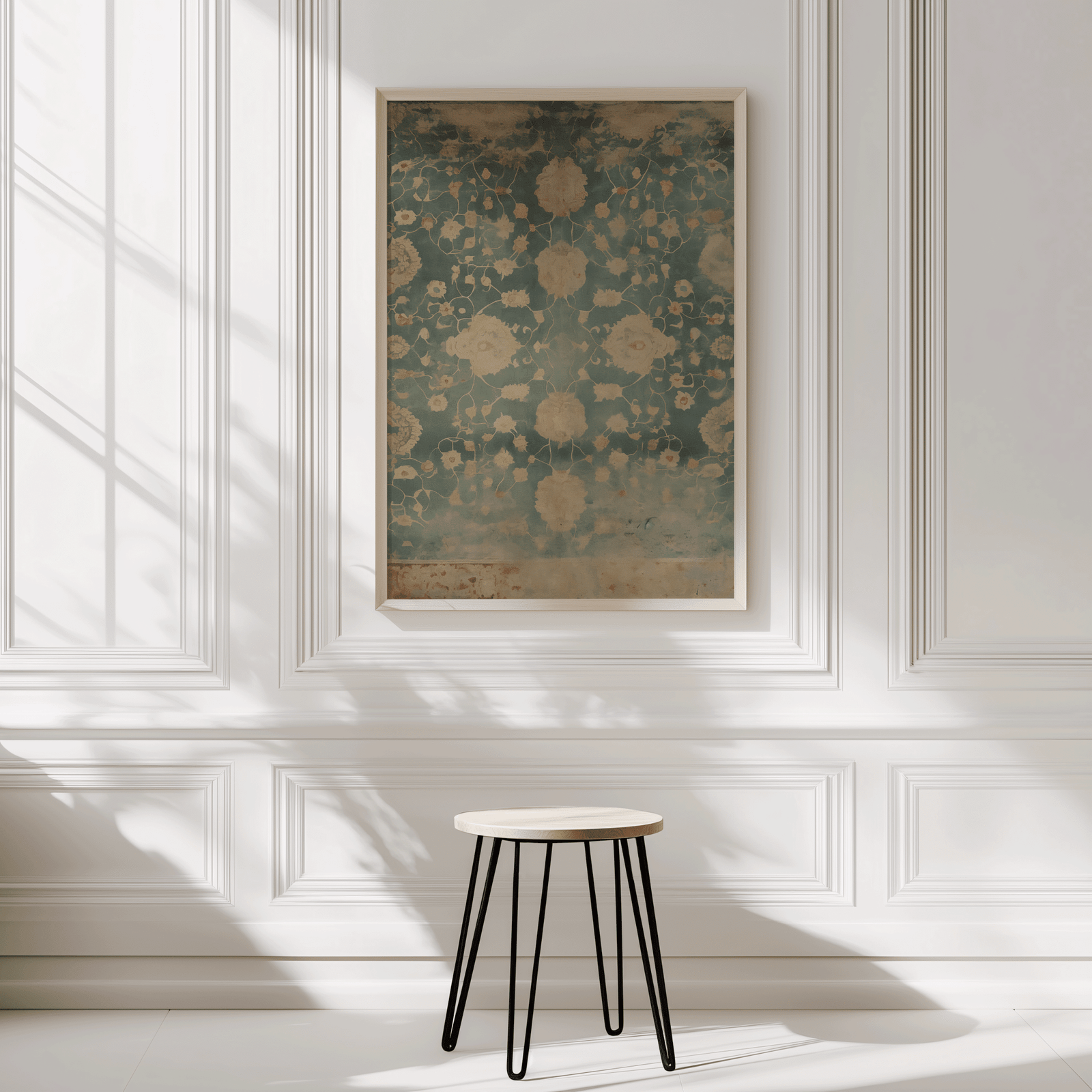 Framed abstract tapestry-inspired floral wall art on a wall with a small stool in front
