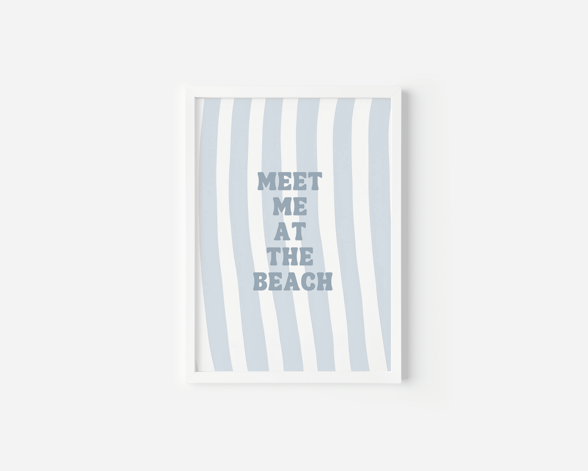 White framed meet me at the beach wall art on a plain white background