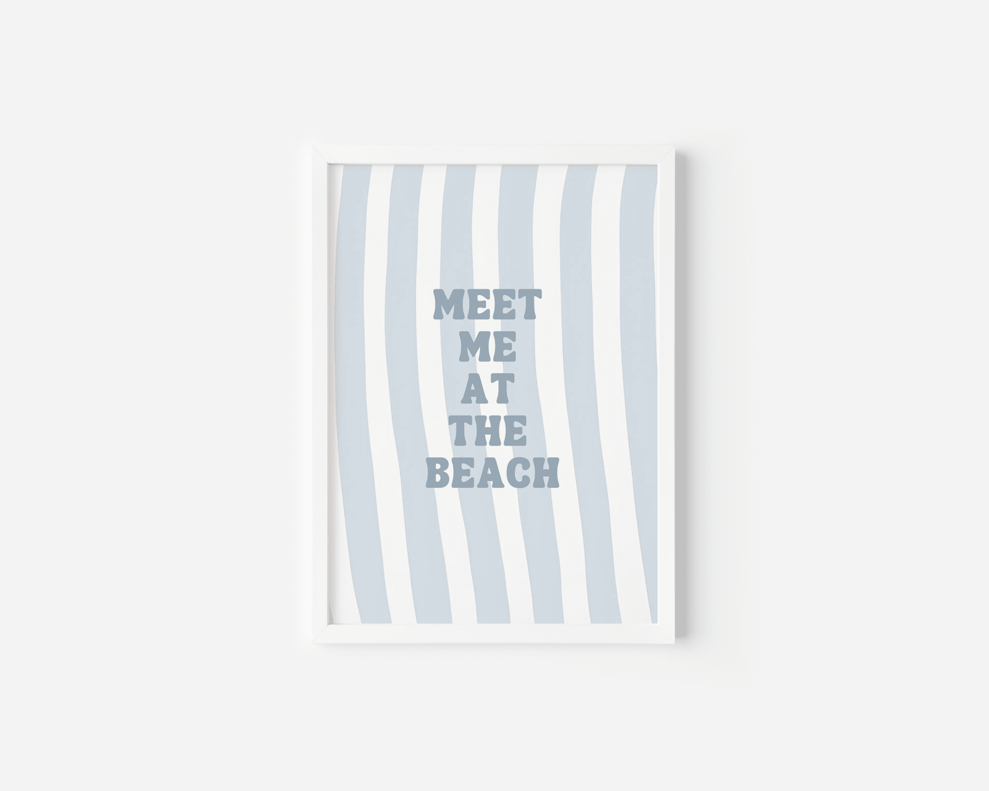 White framed meet me at the beach wall art on a plain white background