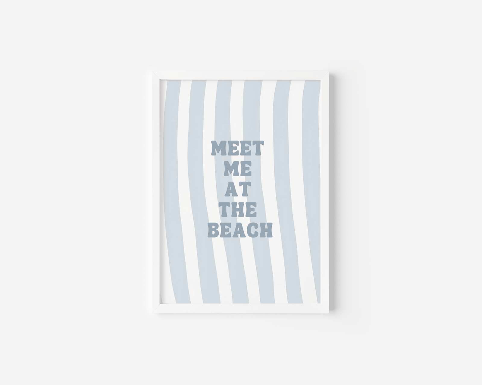 White framed meet me at the beach wall art on a plain white background