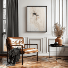 Extra large neutral and minimal abstract wall art framed in black above leather chair and pampas grass in modern living room