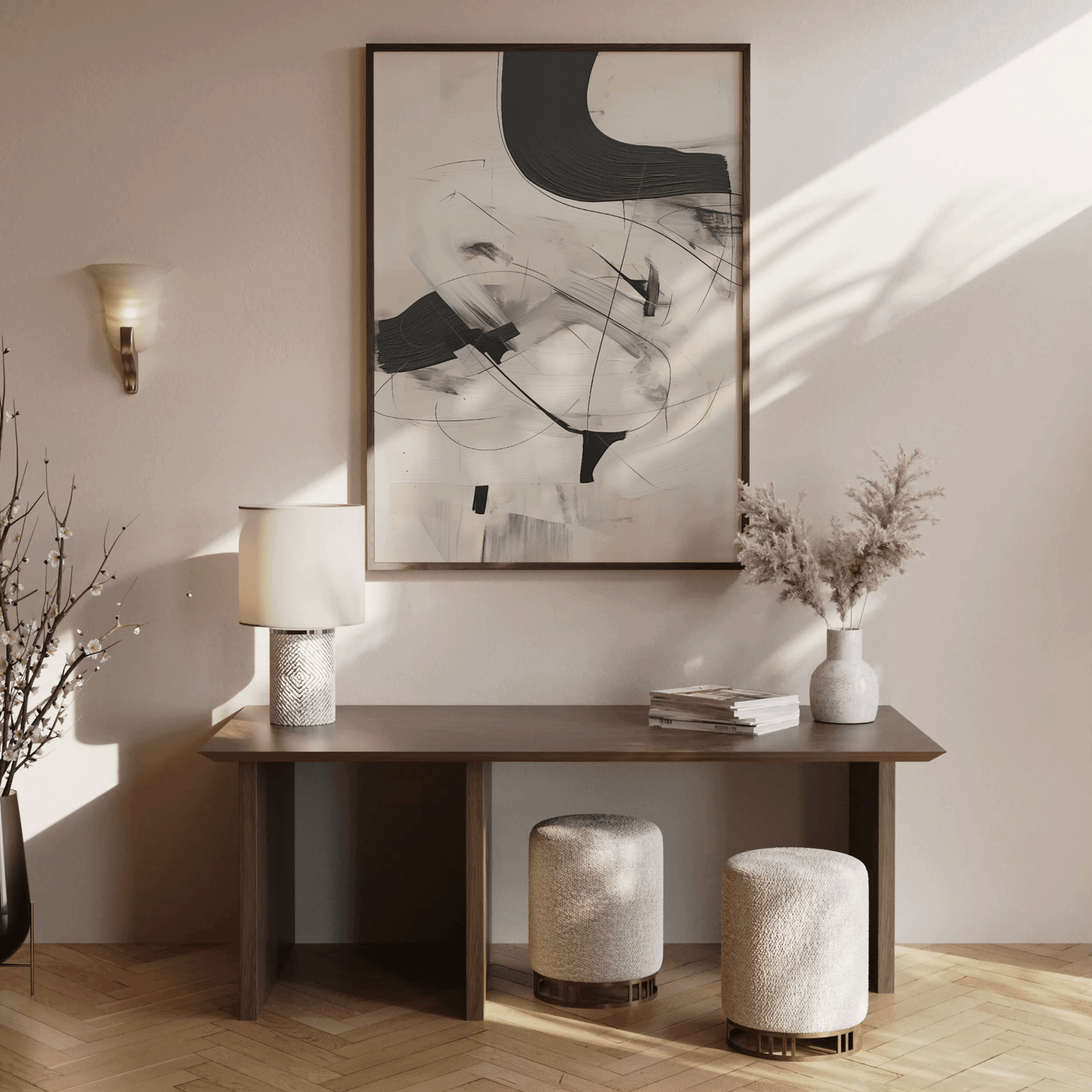 Minimalist black and white abstract wall art print in a walnut frame above a brown wooden console table with neutral decor in a softly lit entryway or hallway.