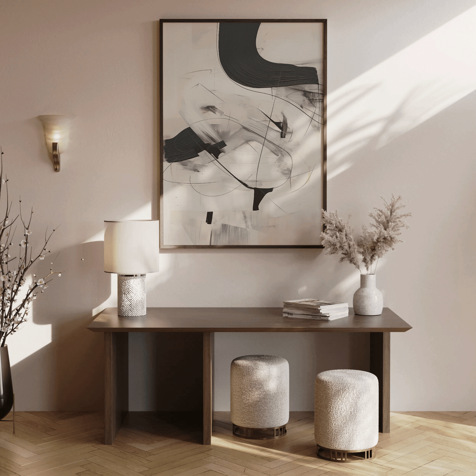 Minimalist black and white abstract wall art print in a brown frame above a brown wooden console table with neutral decor in a softly lit entryway or hallway.