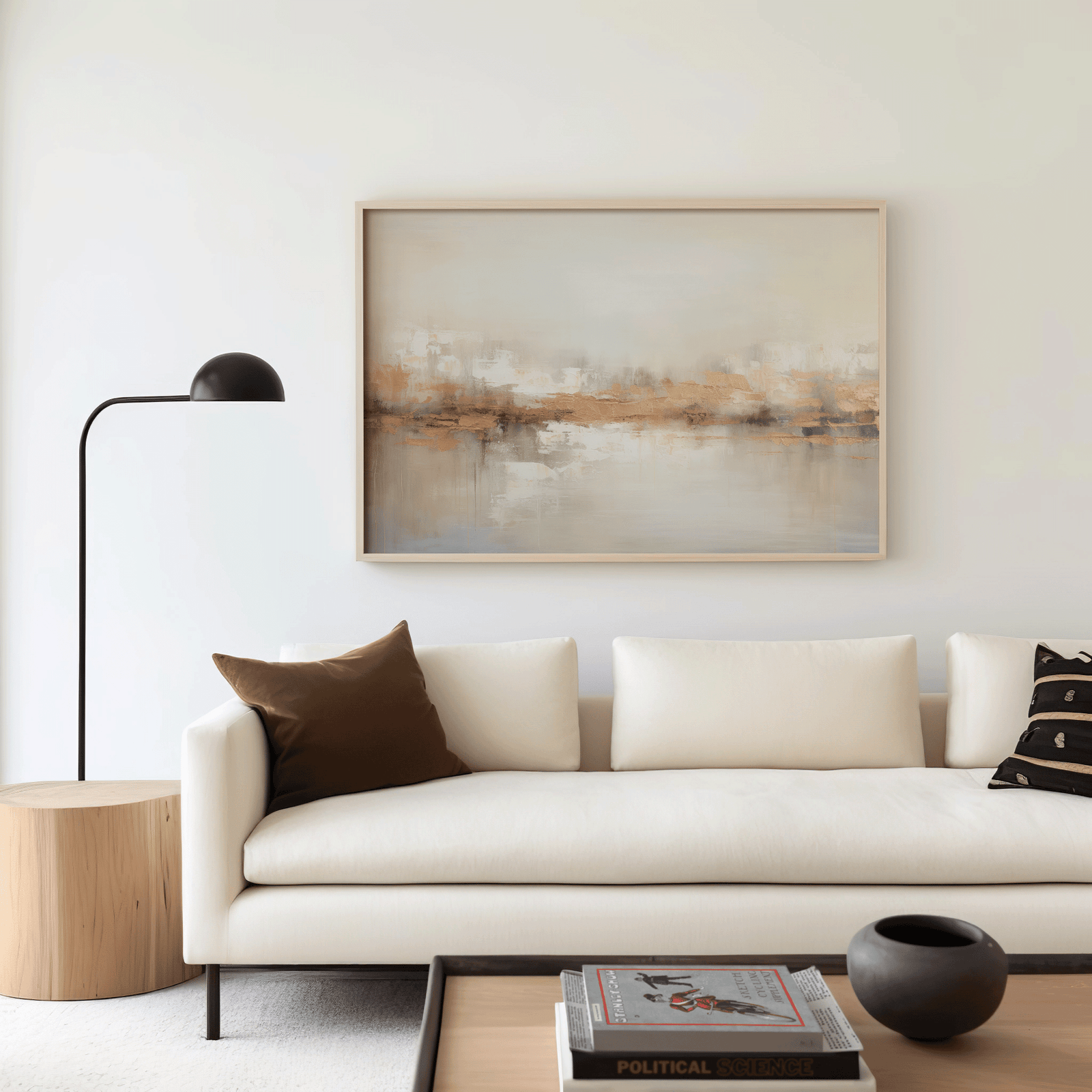 Minimalist living room with beige sofa and neutral gold abstract wall art framed in light wood