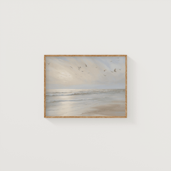 Framed coastal beach wall art featuring calm ocean waves and soft sunlight — neutral beige tones ideal for modern coastal home decor