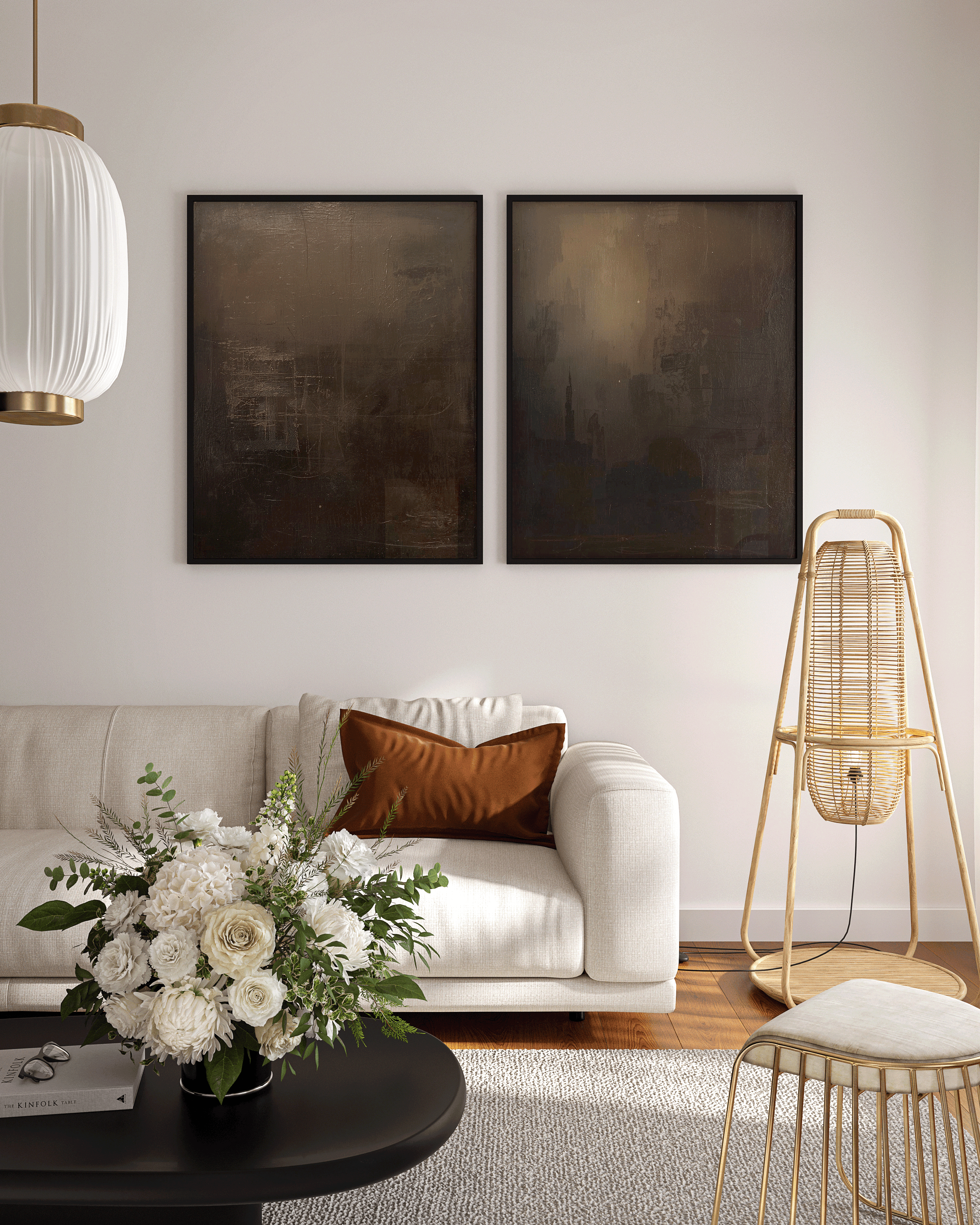 modern abstract wall art pair in deep black and brown tonal shades framed above a cream sofa with gold accents and a floral arrangement, ideal for luxury living room or entryway décor