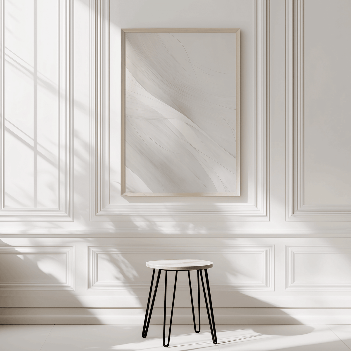 Modern large wall art featuring light grey and white abstract design with minimal flowing lines on a white wall with a stool in front