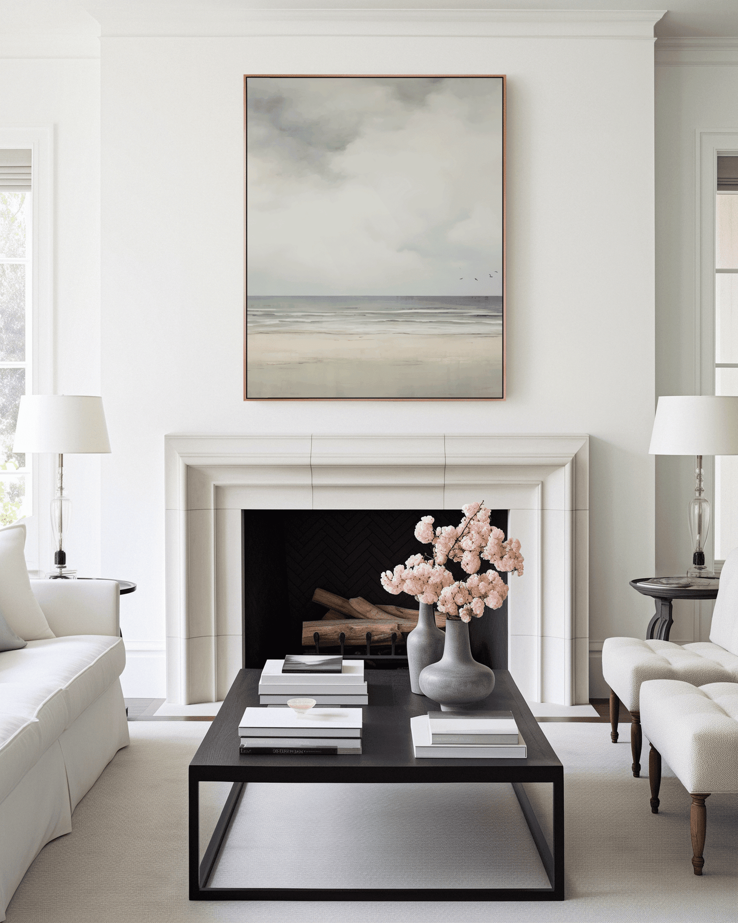 Modern living room with a fireplace, coffee table, and vintage muted beach coastal landscape framed above fireplace.