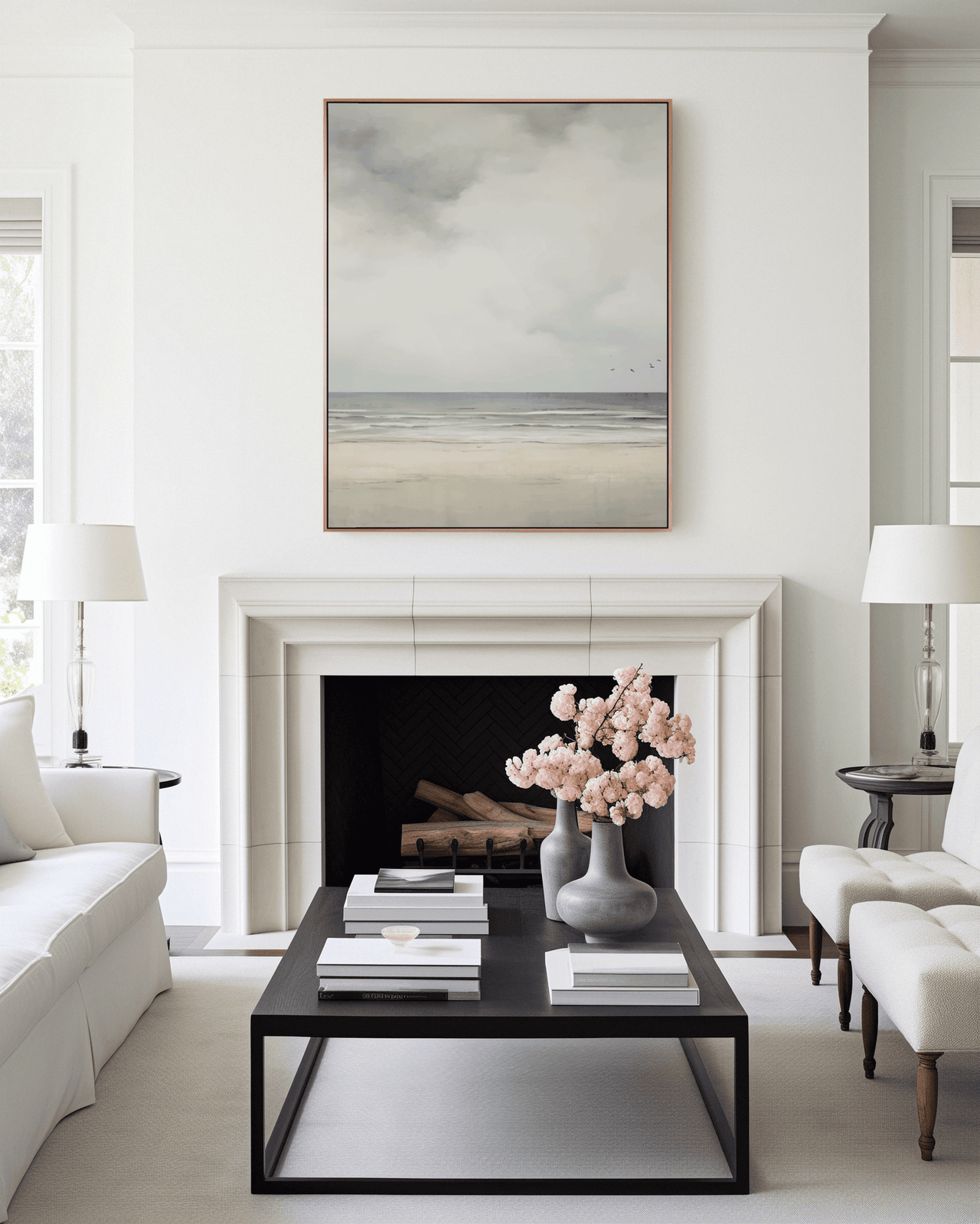 Modern living room with a fireplace, coffee table, and vintage muted beach coastal landscape framed above fireplace.