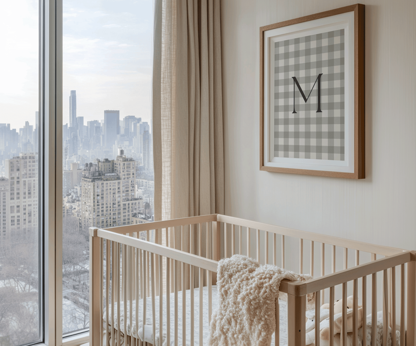 framed gingham baby monogram letter M print above a minimal wooden crib with city view, modern neutral nursery wall art