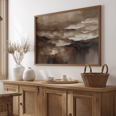 Moody brown abstract wall art in a wood frame above a rustic dining room sideboard