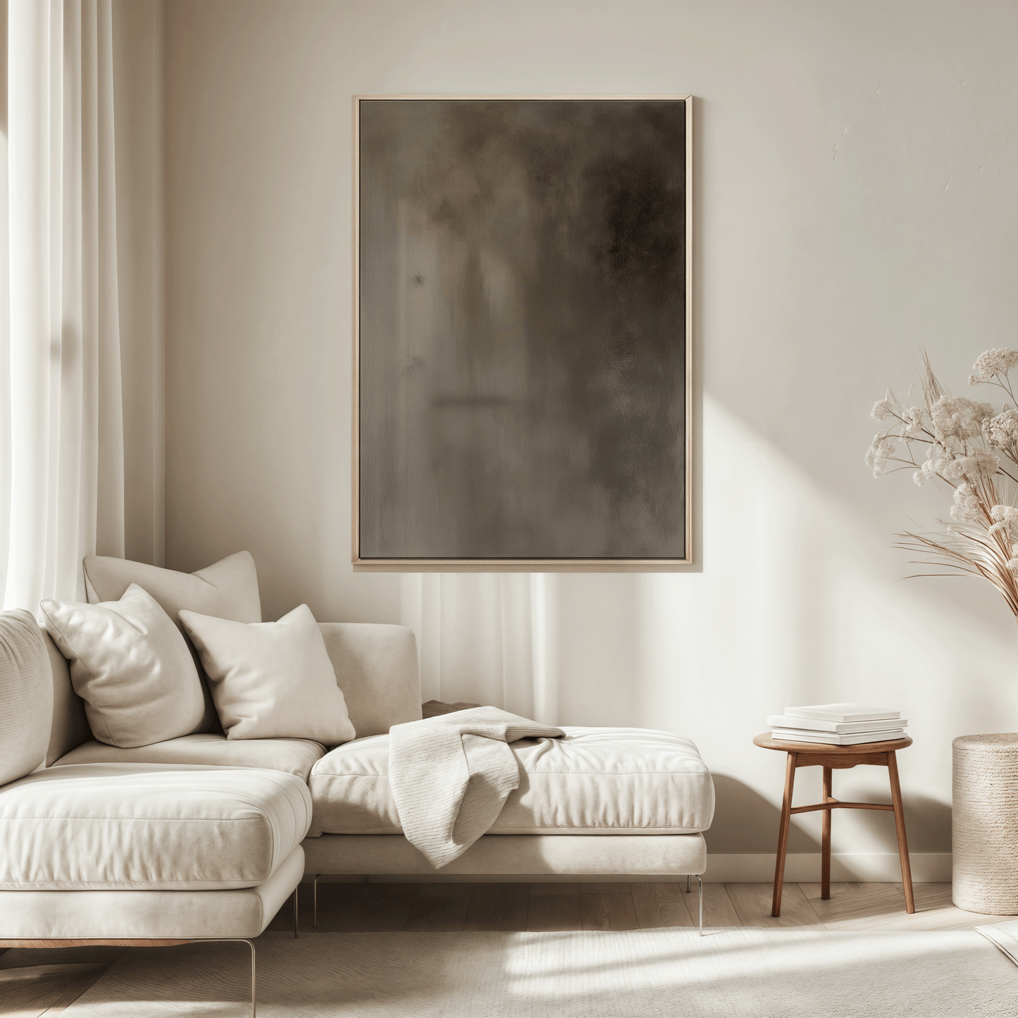 Large moody earthy abstract wall art in natural wood frame above beige sectional sofa in a neutral living room