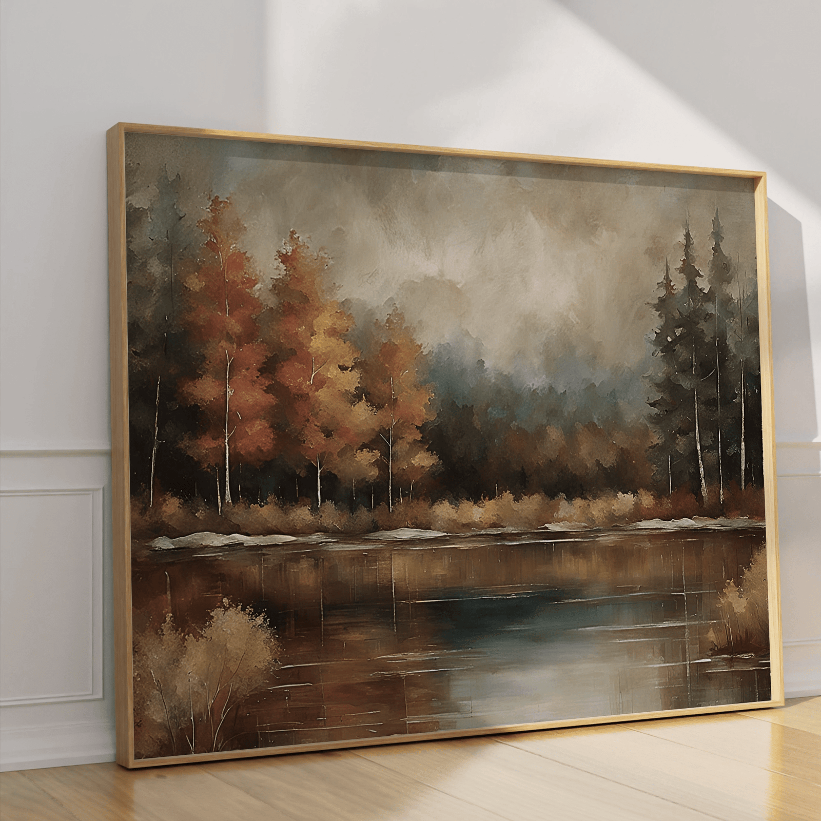 Moody fall landscape wall art in natural frame leaning against a wall