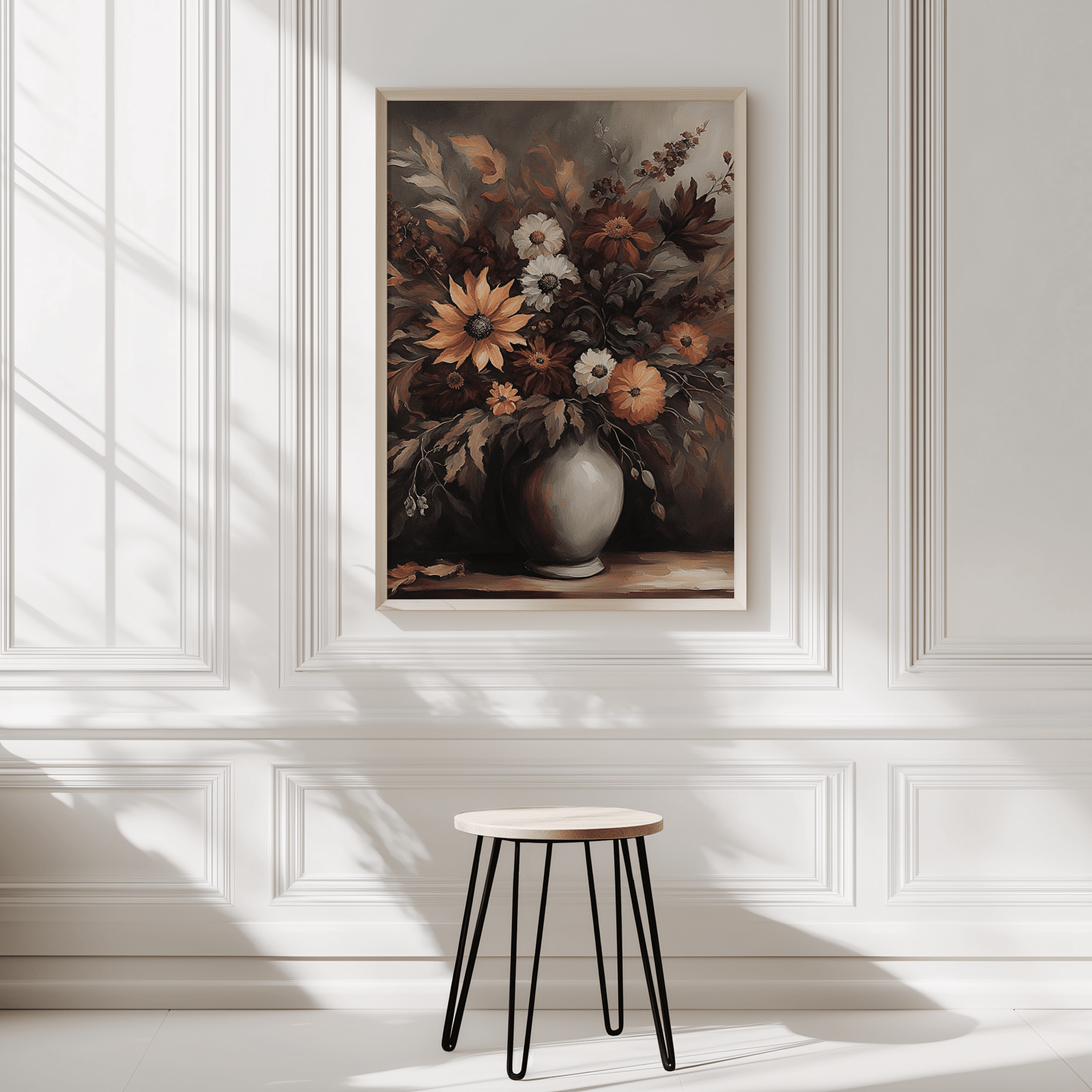 Moody floral print in a natural frame on a white panelled wall above a black stool