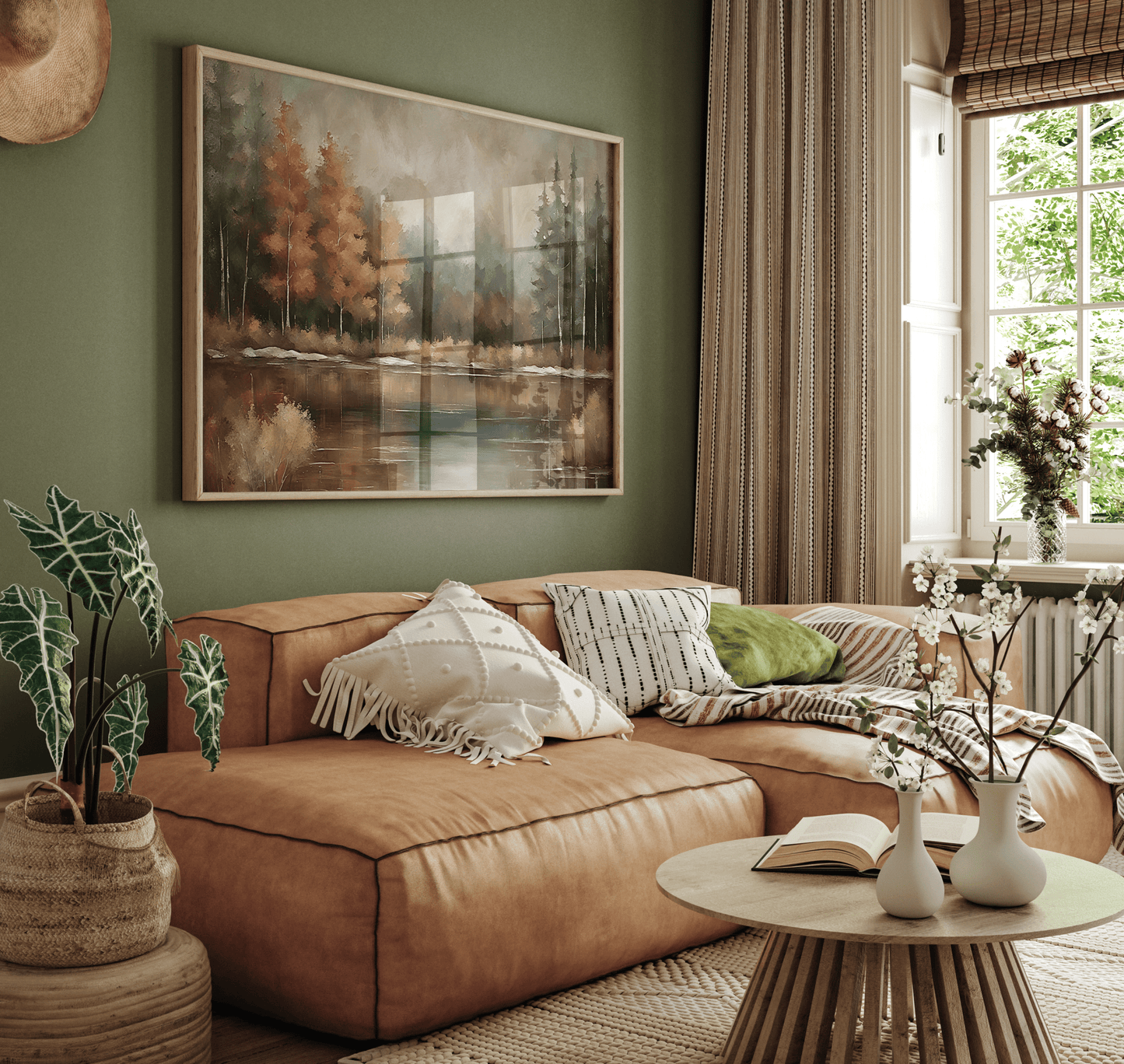 Large moody landscape wall art in natural frame above a tan sofa in a green living room
