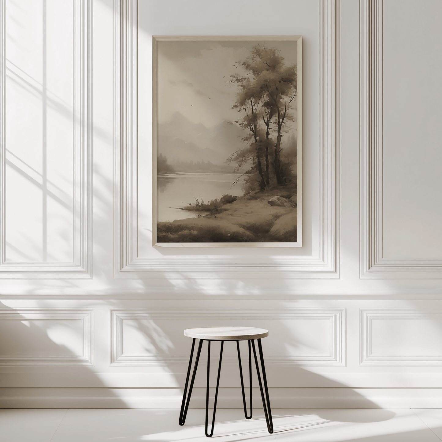 moody vintage landscape wall art in white frame on paneled wall above stool neutral decor