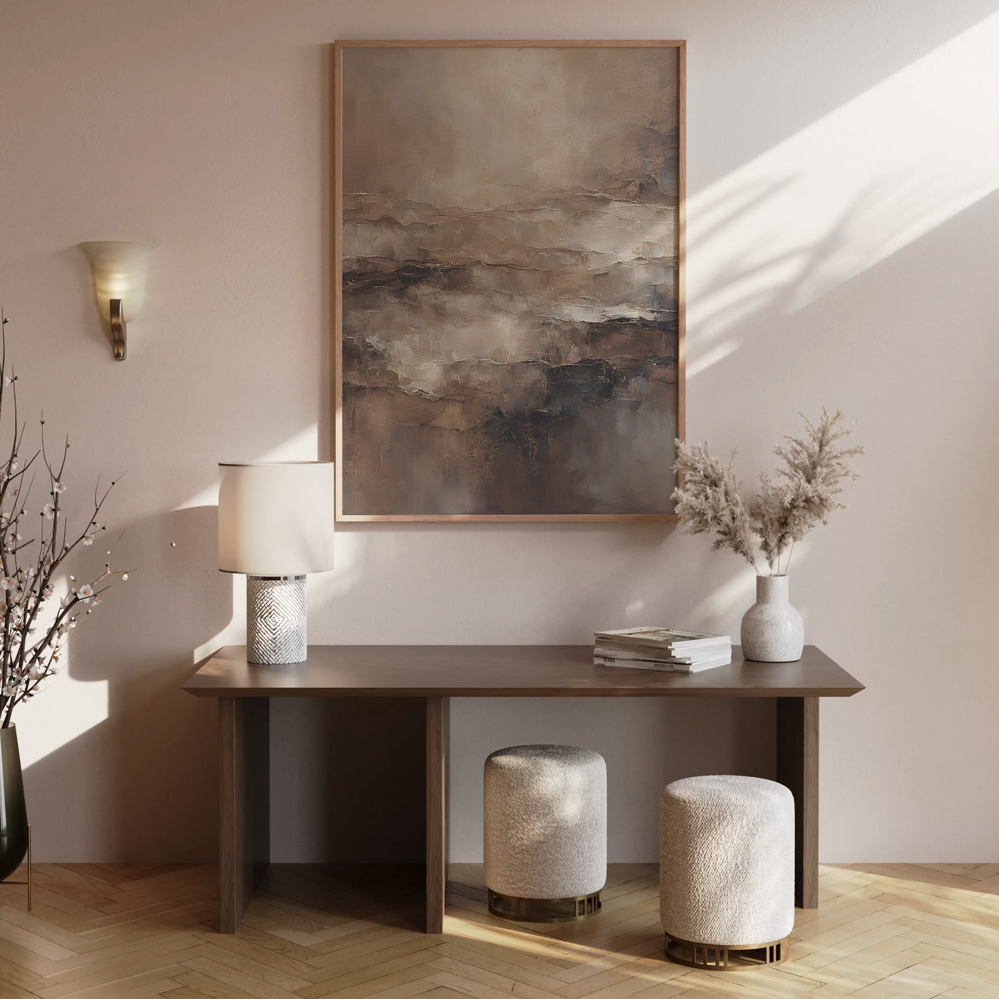 Moody abstract wall art in beige and brown tones framed above a modern console table with neutral home decor