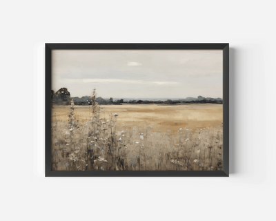 A framed vintage landscape canvas print of a dry grassy field under a cloudy sky, presented in a black frame on a white wall.