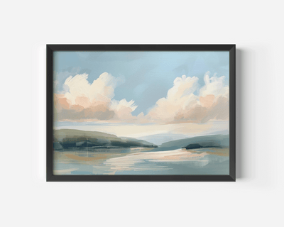 Framed airy coastal landscape wall art with a black frame with clouds and water on a white wall