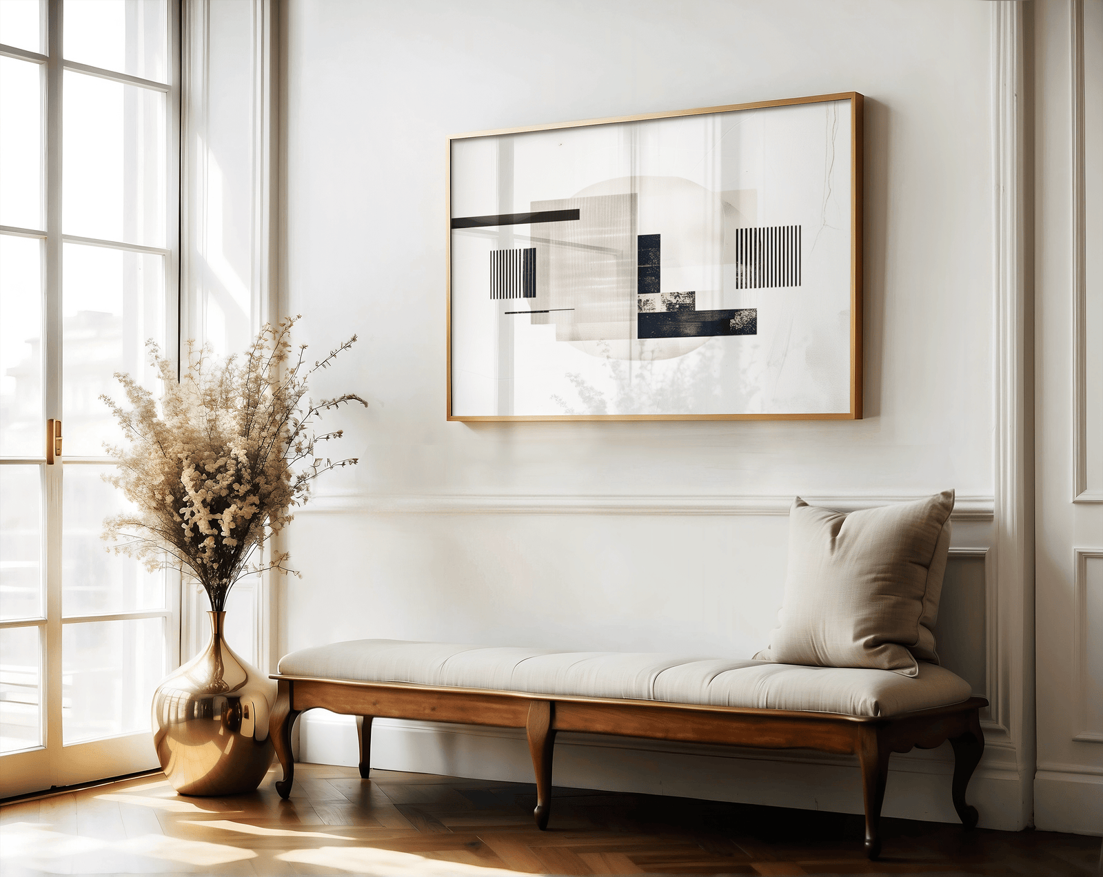 Abstract mid-century modern geometric print with a gold frame with black, beige, and taupe lines above a bench in a hallway