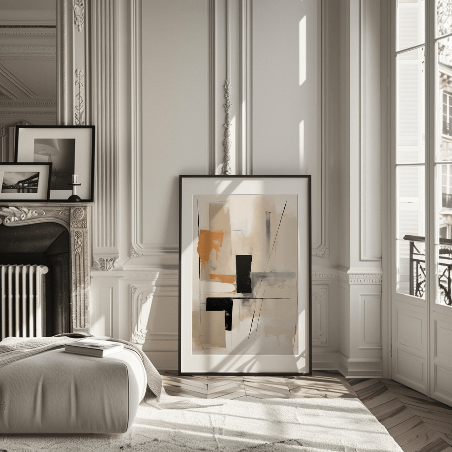 Neutral abstract wall art with tan, camel and black geometric blocks leaning against a wall in a Paris-style living room apartment.