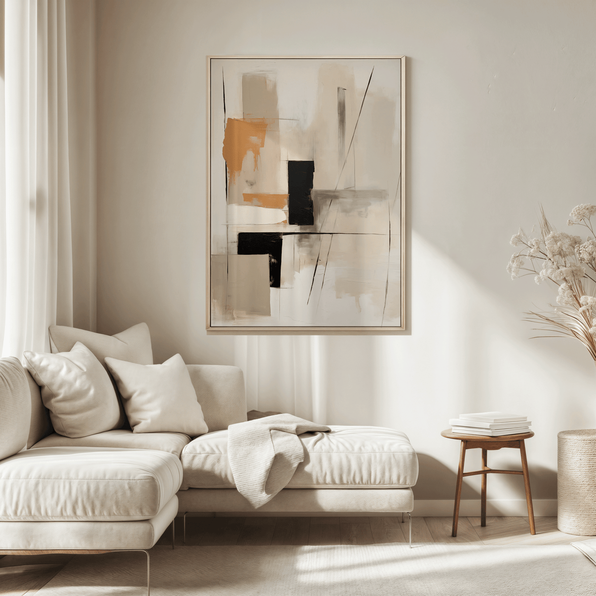 Large tan and black geometric abstract wall art framed and hung above a light cream sectional in a sunlit modern living room.