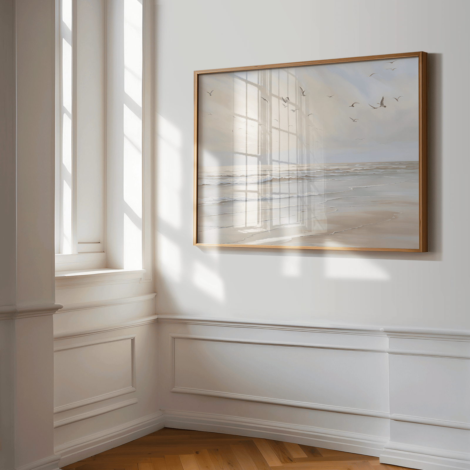 Coastal beach print framed in natural wood featuring seagulls over soft ocean waves in a white hallway or entryway — calming artwork for minimalist interior styling