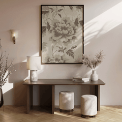 Neutral green botanical wall art framed above brown wooden console table with vases and dried branches in minimalist entryway or hallway