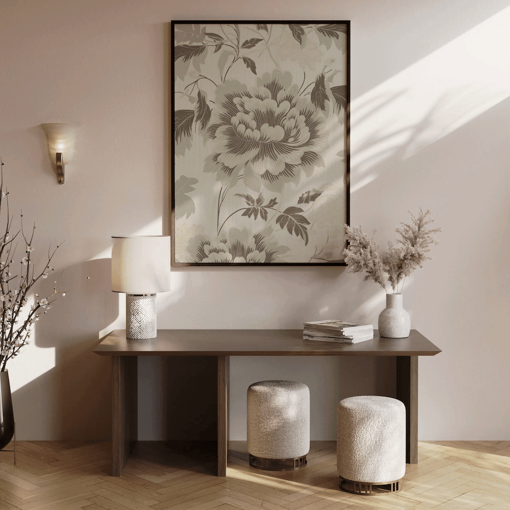 Neutral green botanical wall art framed above brown wooden console table with vases and dried branches in minimalist entryway or hallway