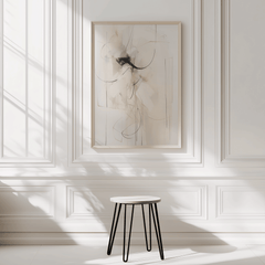 Large neutral minimal abstract wall art in light wood frame on sunlit white panelled wall with beige, cream, brown and black