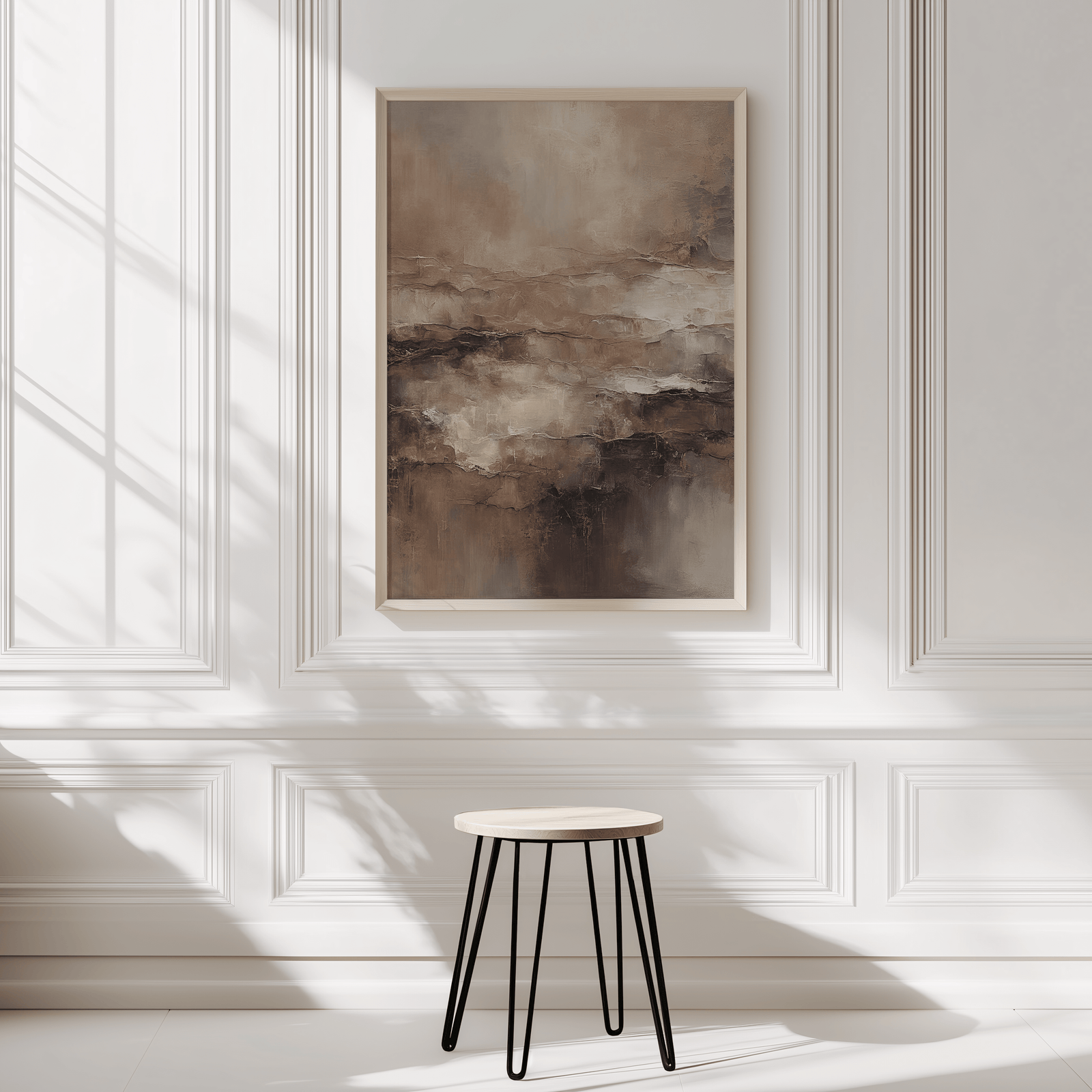 Neutral moody abstract wall art framed in light wood against white panelled white wall