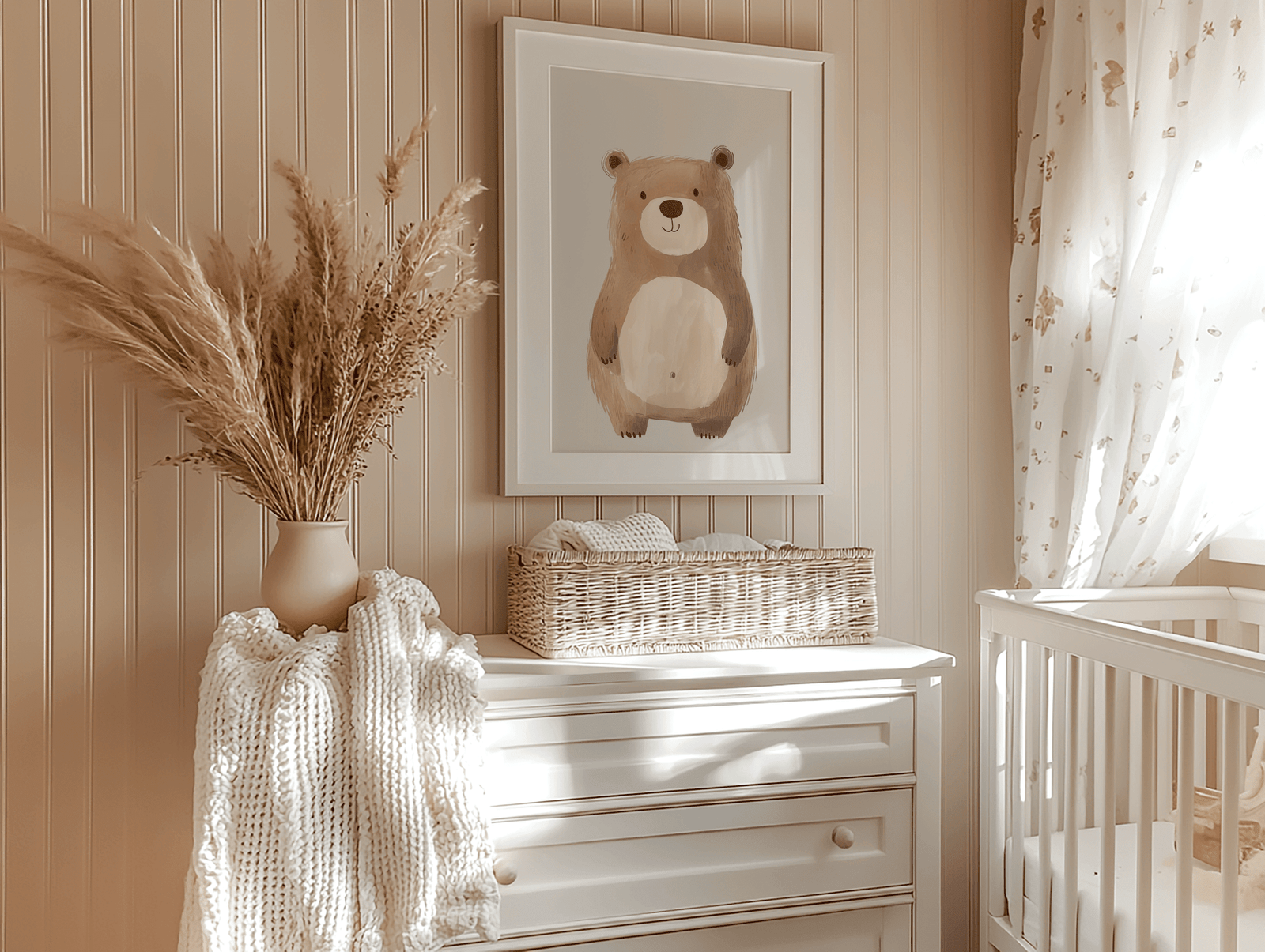 A neutral vintage teddy bear nursery wall art with a white frame styled above dresser with pampas grass in warm neutral baby room