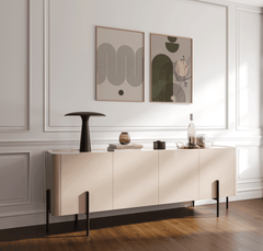 Olive green and blush abstract wall art set in wood frames above a cream console in a bright dining room