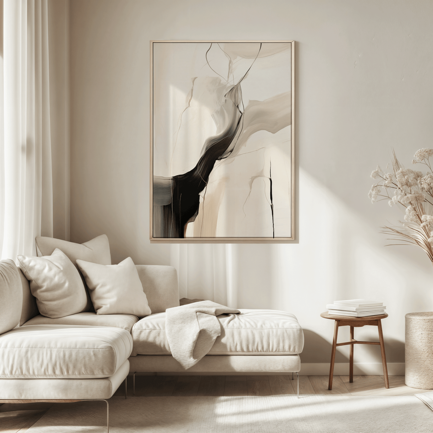 Modern living room with a neutral color scheme featuring a beige sofa, a large black, beige and grey abstract wall art print framed above the couch, and minimal decor.