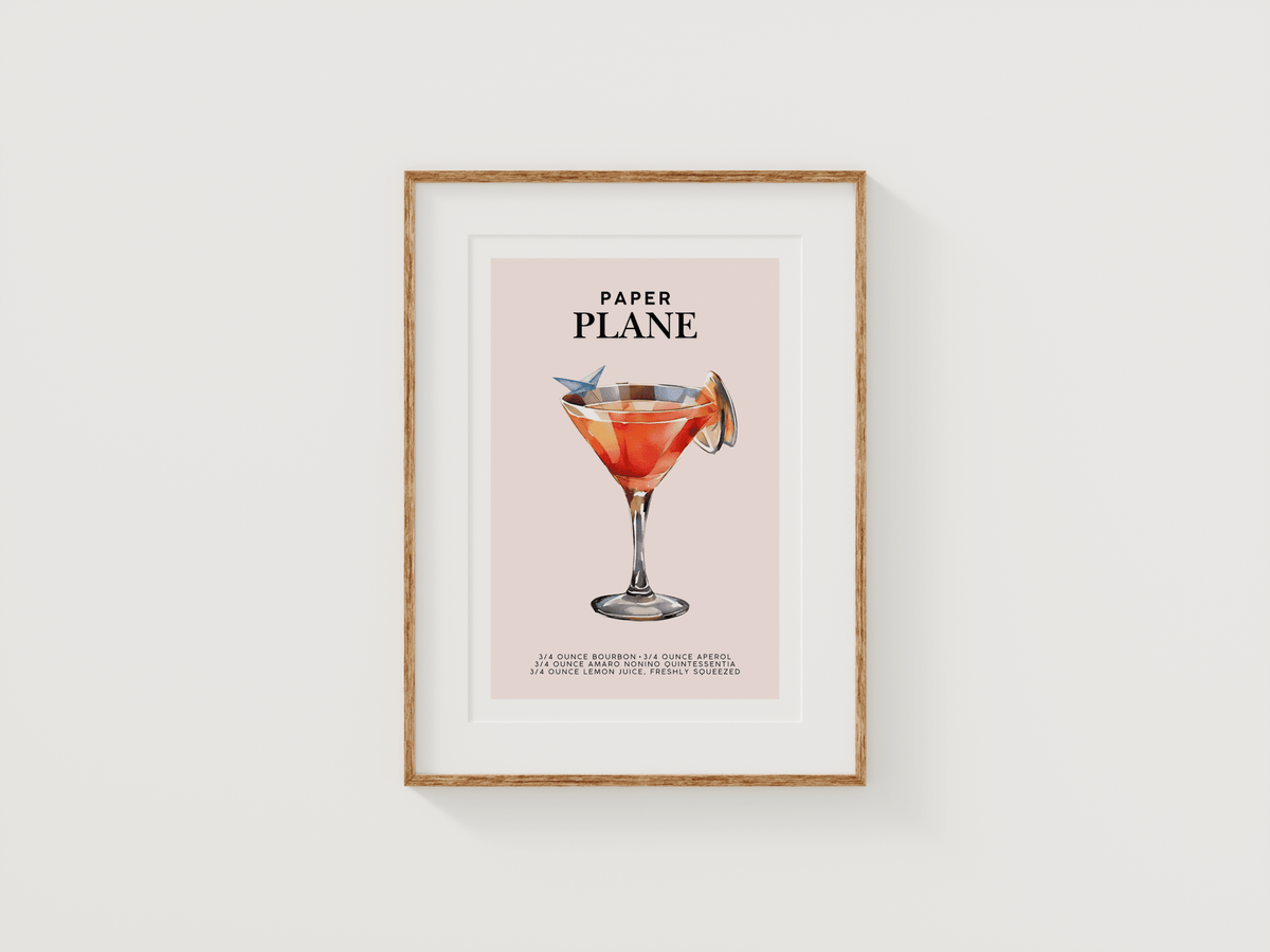 Paper Plane cocktail print in a small natural wood frame on a white background