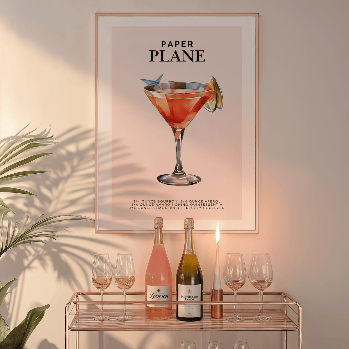 Paper Plane wall art in a natural frame above a glass bar cart with wine bottles and a candle