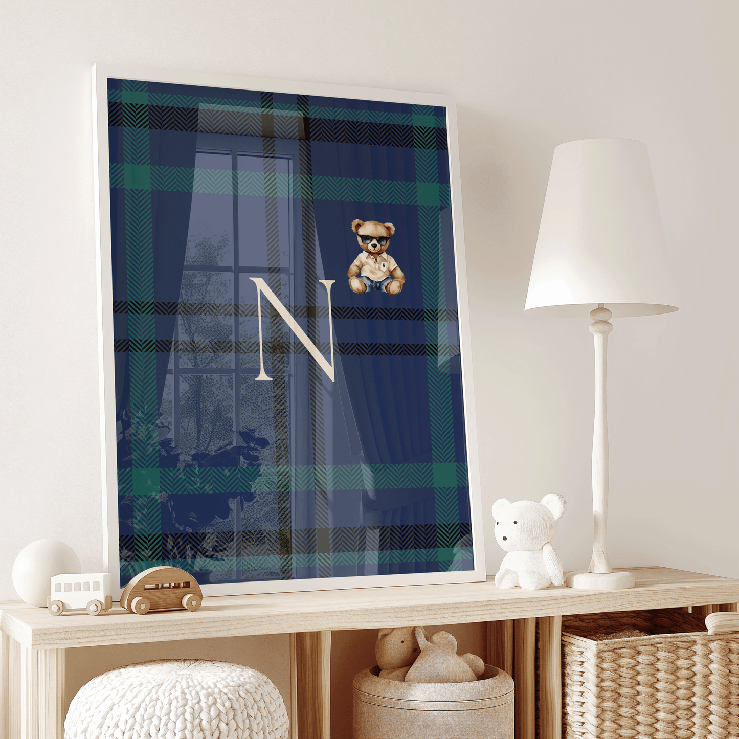 Elegant framed plaid monogram nursery artwork with teddy bear and letter N styled on wood shelf with toys, luxury toddler room decor, timeless prep-school baby aesthetic and personalization trend
