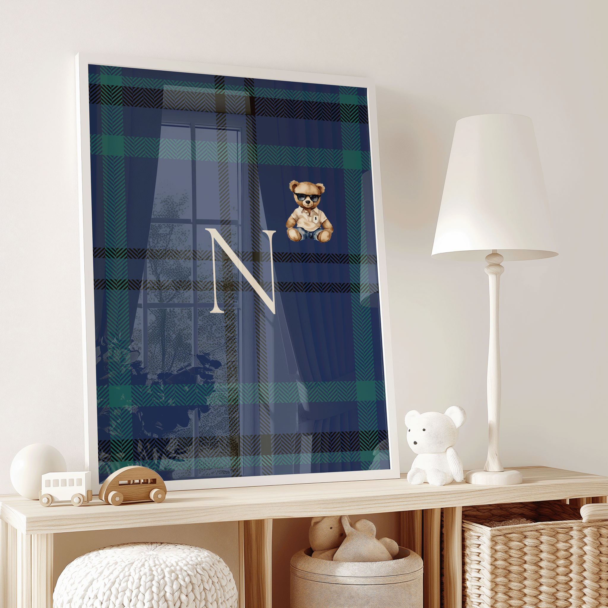 Elegant framed plaid monogram nursery artwork with teddy bear and letter N styled on wood shelf with toys, luxury toddler room decor, timeless prep-school baby aesthetic and personalization trend