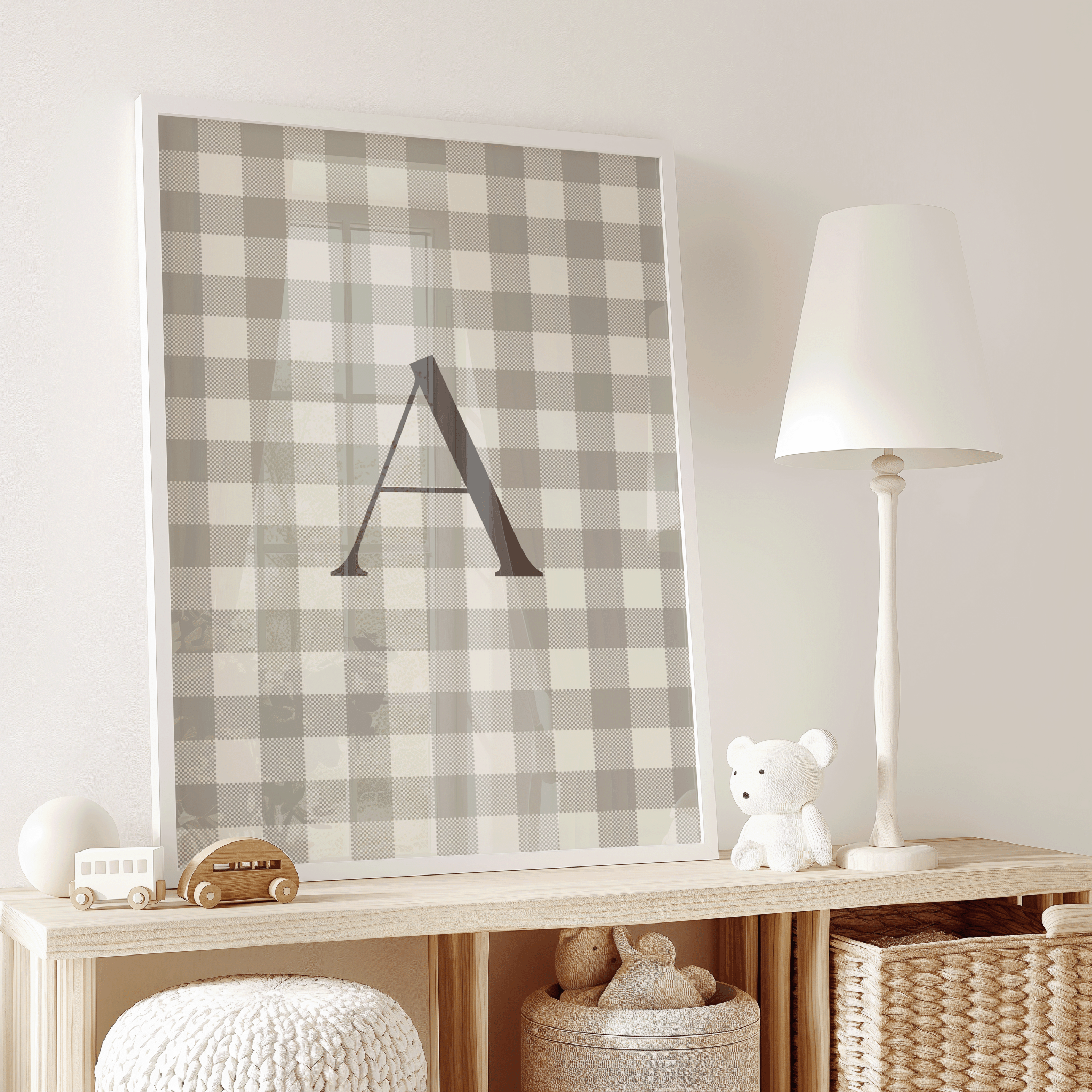 framed beige gingham baby initial letter A art displayed on nursery shelf with toys, minimalist baby room wall decor