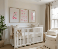 Nursery room with a white crib, teddy bear, and set of 3 pink coquette bow wall art framed prints