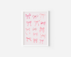 A white framed canvas wall art print featuring watercolor illustrations of various pink coquette bows in different styles, displayed against a white wall.
