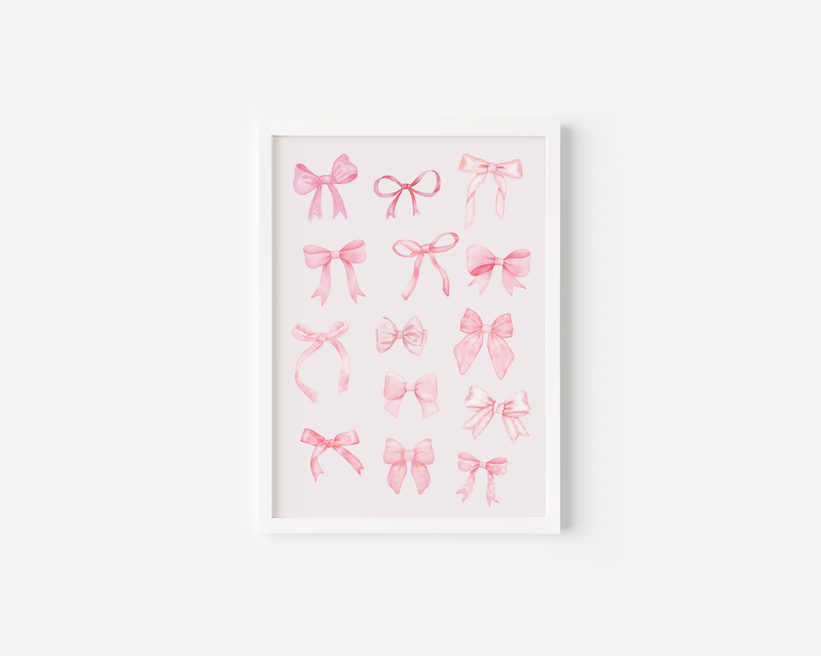 A white framed canvas wall art print featuring watercolor illustrations of various pink coquette bows in different styles, displayed against a white wall.