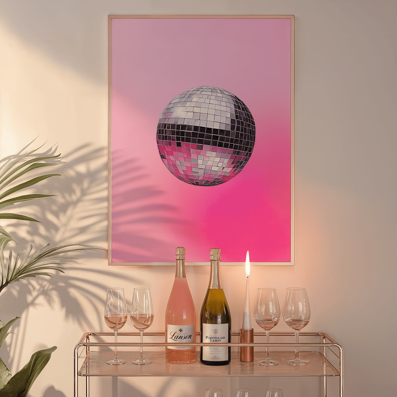 Pink disco ball print in a natural frame above a glass bar cart with wine bottles and a candle