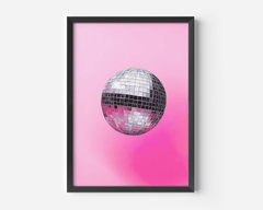 Pink disco ball wall art with a silver mirror ball in a black frame