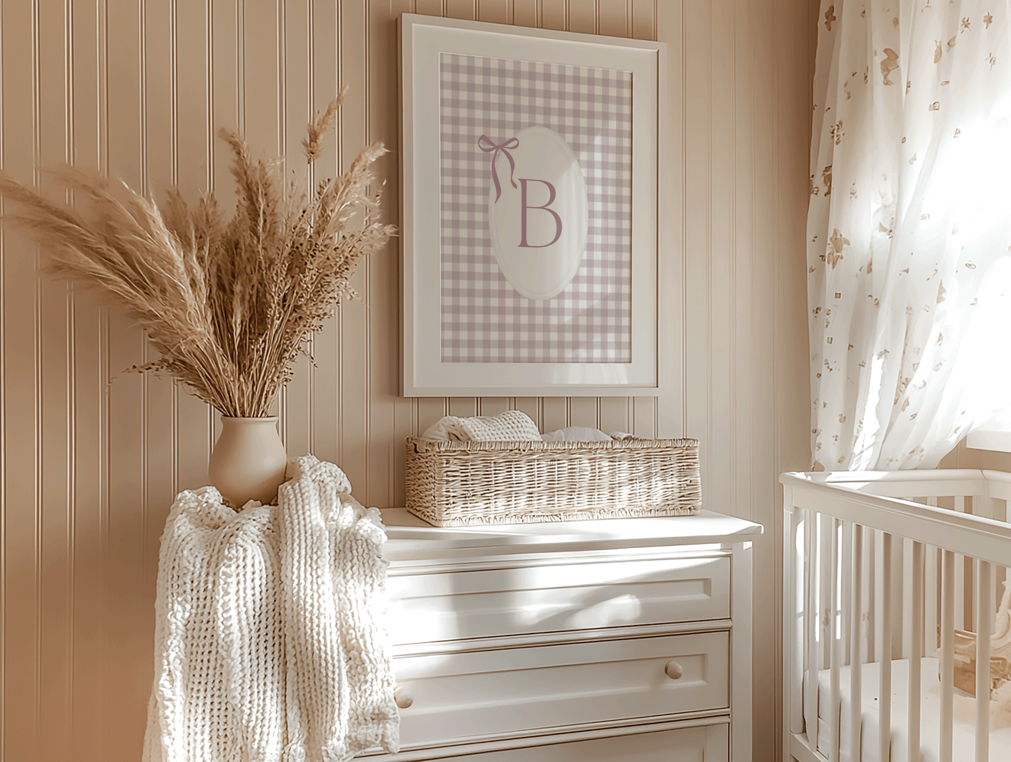Personalized baby girl nursery wall art with gingham monogram letter B hanging above dresser and vase in a boho vintage nursery