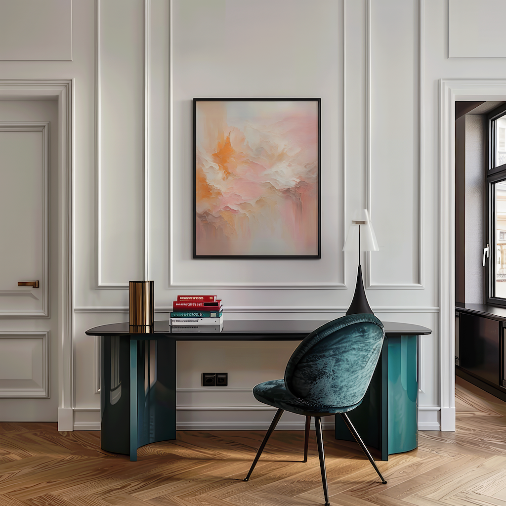 Blush pink and orange abstract wall art framed in black above sleek home office desk