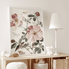Pink rose floral print on a white dresser beside a lamp in a baby girl nursery