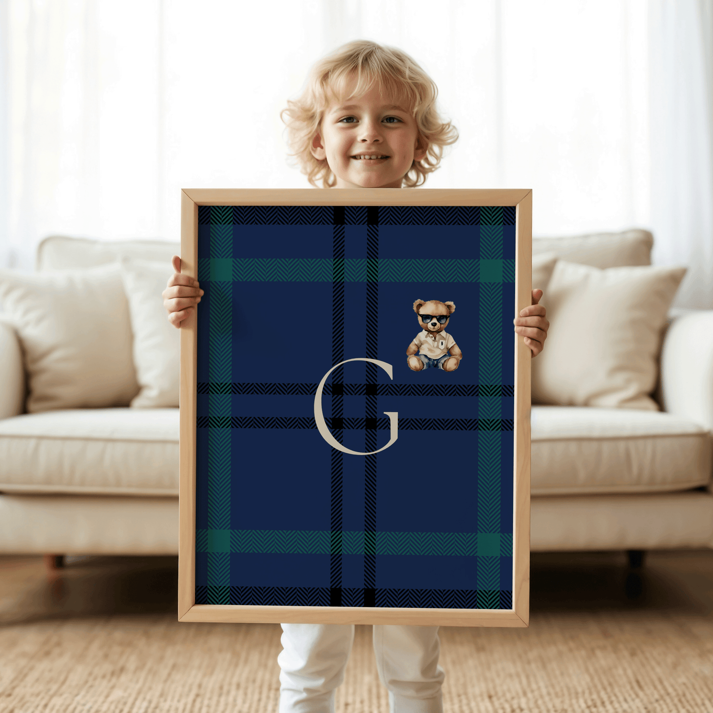Toddler boy holding personalized navy and green plaid monogram nursery print with teddy bear, preppy Ralph-Lauren-inspired kids room decor, classic baby boy wall art for luxury nursery, custom initial baby shower gift