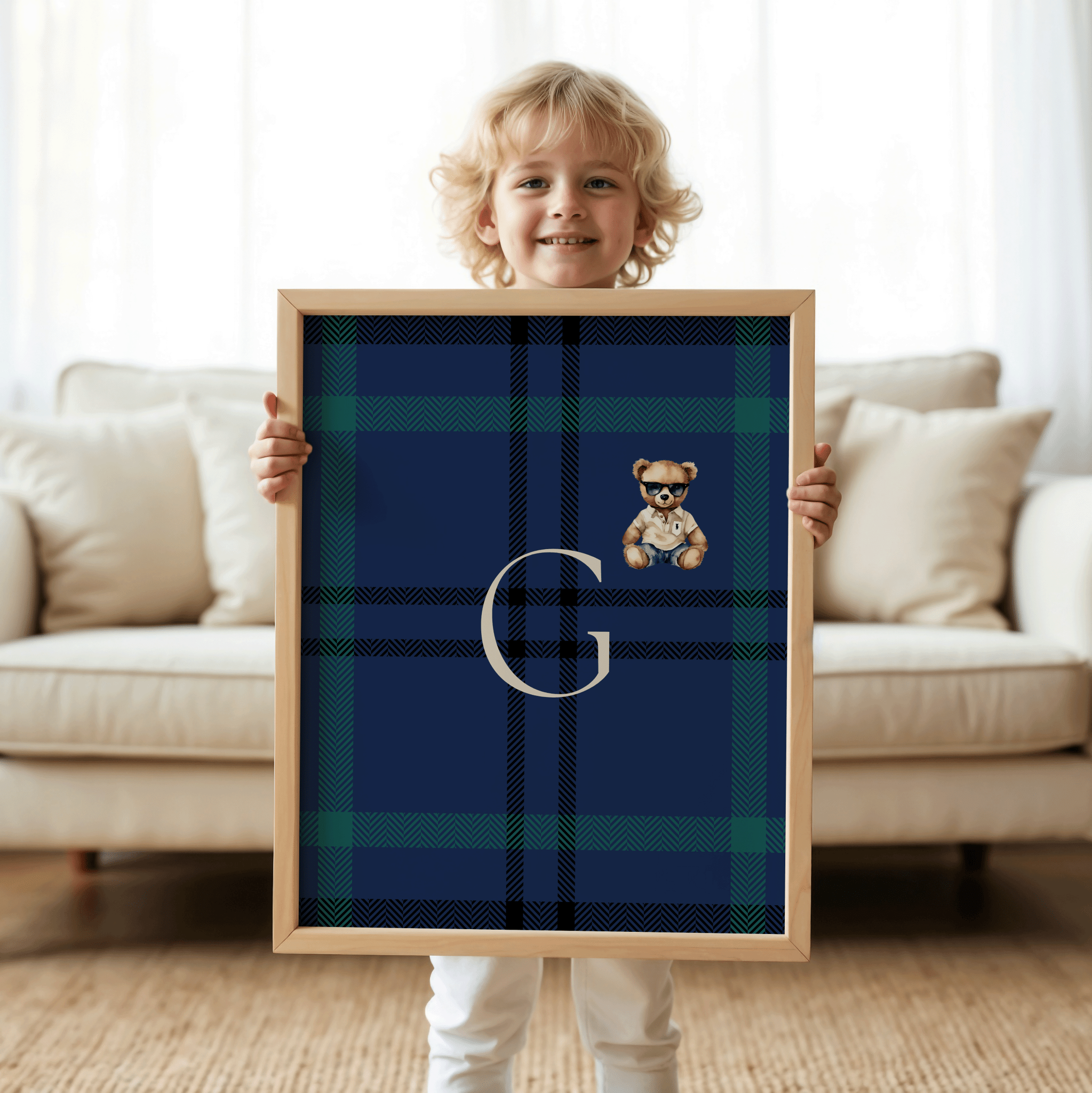 Toddler boy holding personalized navy and green plaid monogram nursery print with teddy bear, preppy Ralph-Lauren-inspired kids room decor, classic baby boy wall art for luxury nursery, custom initial baby shower gift